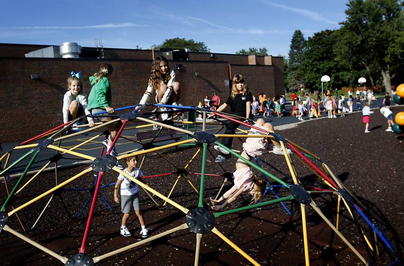 Children play a geodome climber before the the first day of school on Wednesday, Aug. 21, 2024, at Coventry Elementary School in Crystal Lake.