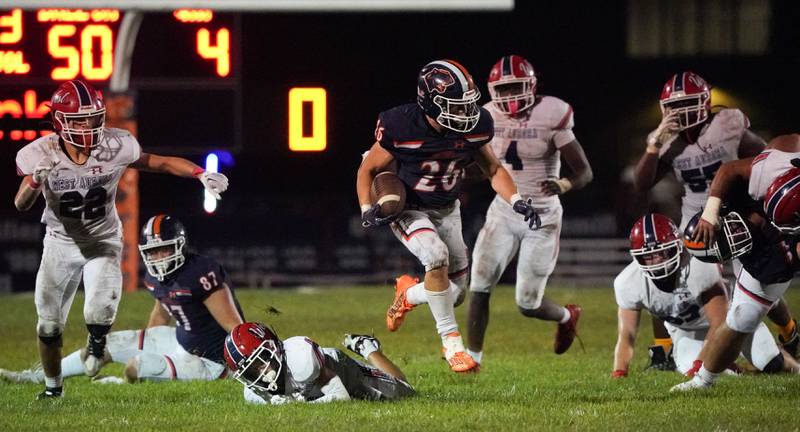 Oswego’s Noah Vera (26) carries the ball against West Aurora during a football game at Oswego High School on Friday, Sept. 29, 2023.