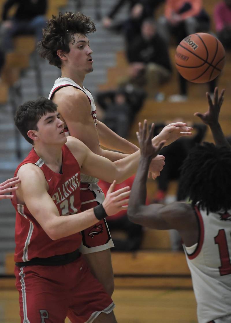 Palatine’s Connor May and Yorkville’s Bryce Salek and Kaevian Johnson, right, battle for the ball in a quarterfinal game of the Jack Tosh Classic at York High School in Elmhurst on Thursday, Dec. 28, 2023.