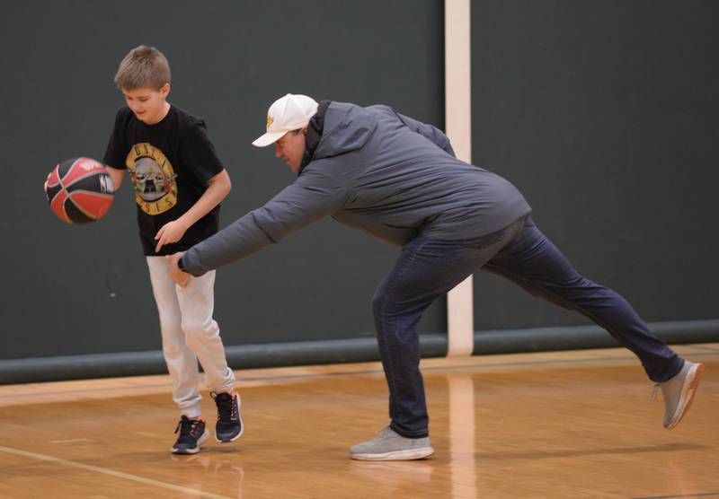 Hunter Bartholome and his dad Michael practice on an open court  during Youth Basketball held at the LaGrange Park District Saturday, Jan 6, 2024.