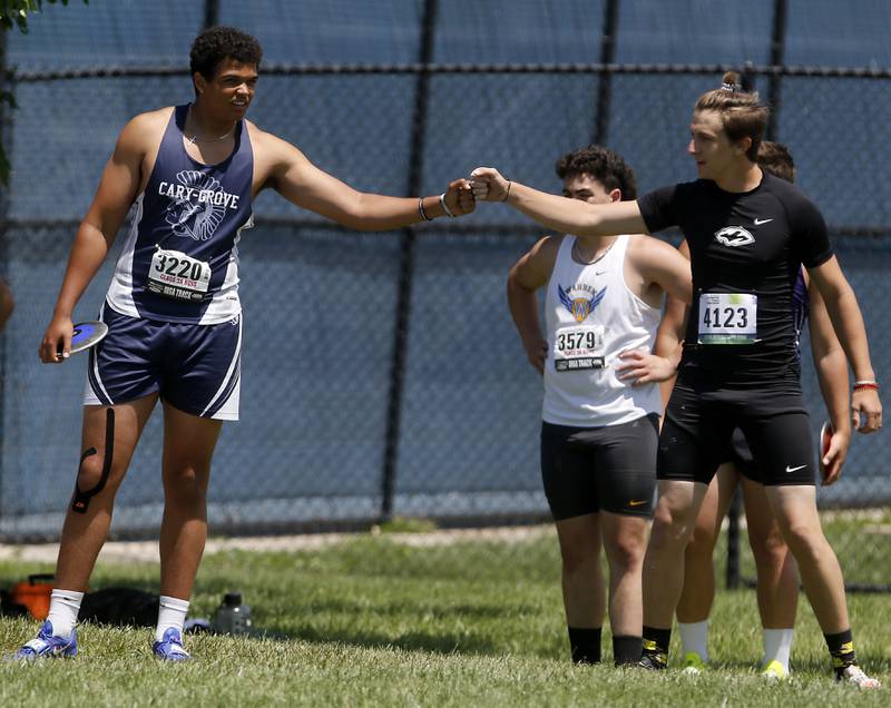 Cary-Grove’s Reece Ihenacho fist bumps Plainfield South’s Joshua Cygan during the IHSA Class 3A Boys State Track and Field Championship meet on Saturday, May 25, 2024, at Eastern Illinois University in Charleston.