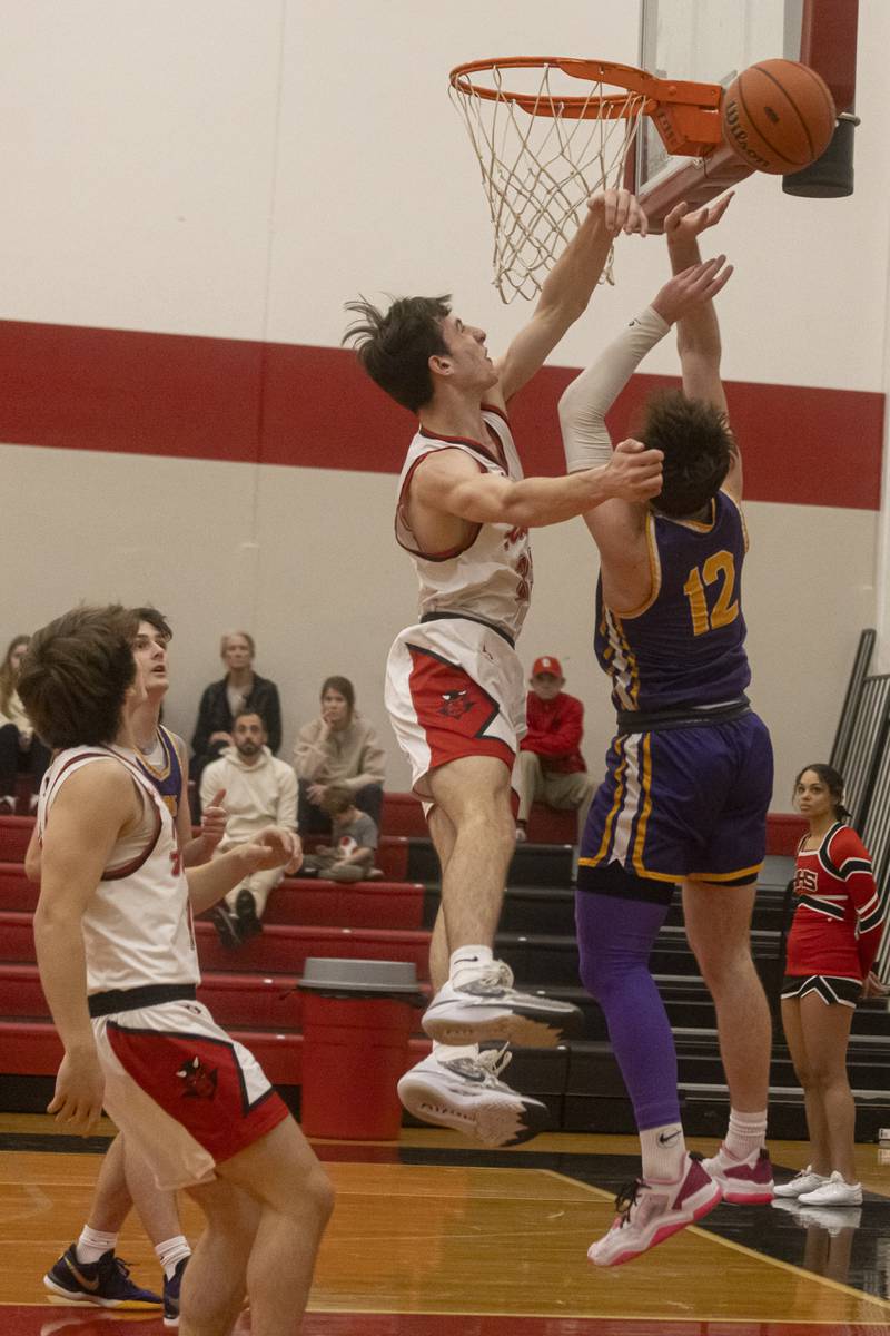 Hall High School's Braiden Curran blocks a shot from Mendota's Braiden Freeman during the IHSA 2A Regional Semifinal at Hall High School on February 19, 2024.