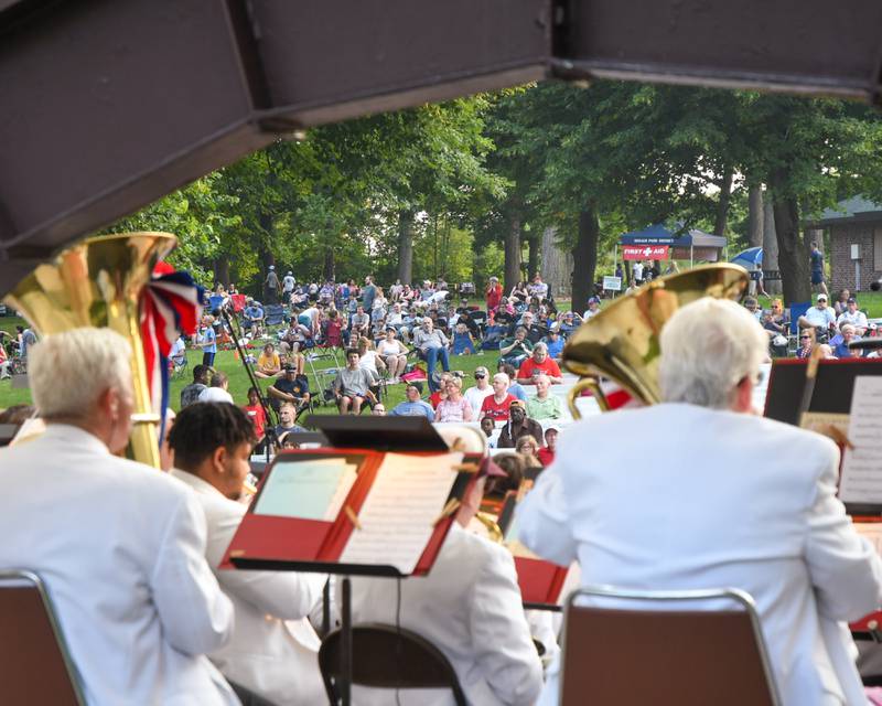 Shaw Local file photo - Patrons look on as the DeKalb Municipal Band performs at the Hopkins Park Bandshell on July 4, 2021.