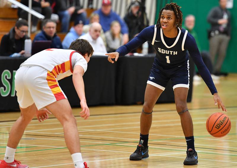 Downers Grove South's Keon Maggitt (1) directs teammates during a Jack Tosh Classic game against Batavia on Dec. 26, 2023 at York High School in Elmhurst.