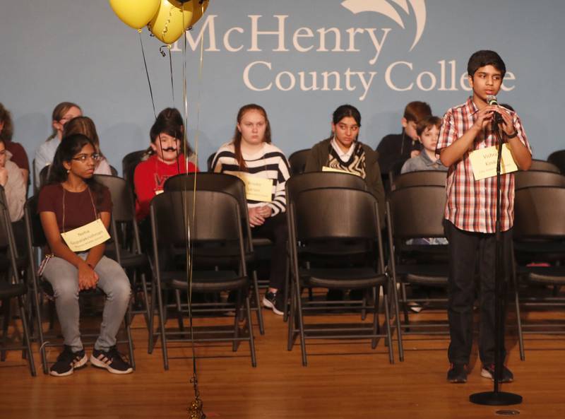 Neha Gopalakrishnan of Marlowe Middle School in Lake in the Hills watches as Vishrut Kinikar of Cary Junior High School spells a word on his way to winning the McHenry County Regional Office of Education's 2023 spelling bee on Wednesday, March 22, 2023, at McHenry County College's Luecht Auditorium in Crystal Lake.