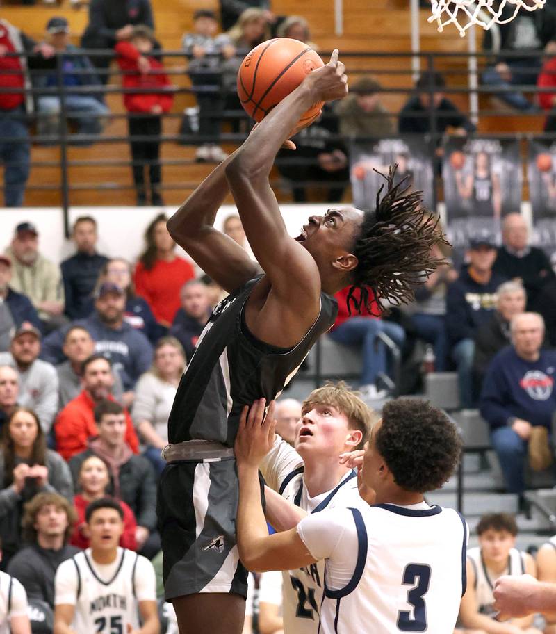 Kaneland's Freddy Hassan shoots a layup in front of two Belvidere North defenders Wednesday, Feb. 28, 2024, during their Class 3A sectional semifinal game at Kaneland High School in Maple Park.