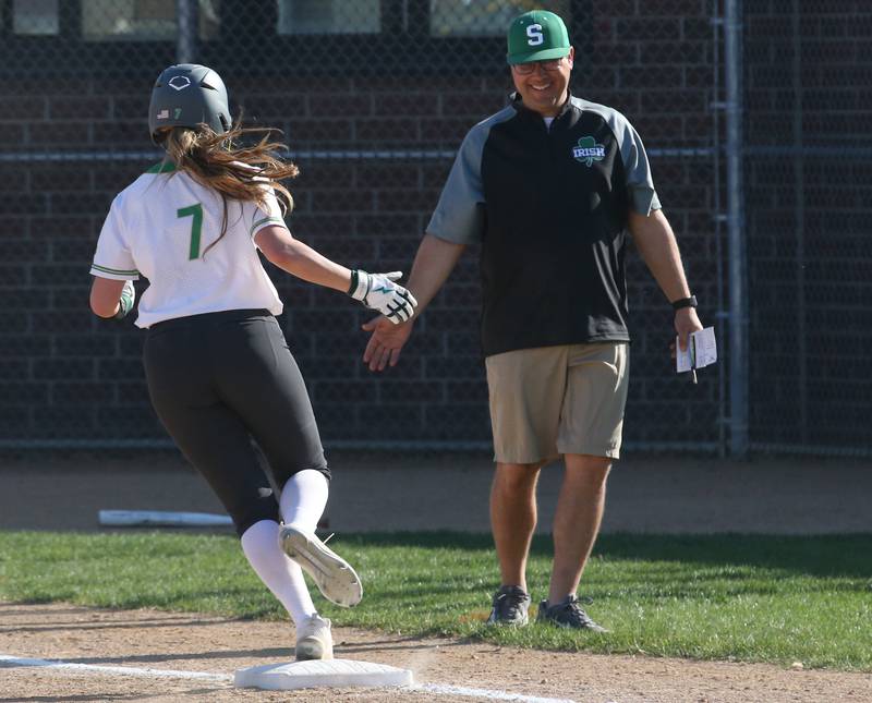 Seneca's Audry McNabb hi-fives head coach Brian Holman while rounding third base after hitting a home run on Thursday, April 13, 2023 at Seneca High School.