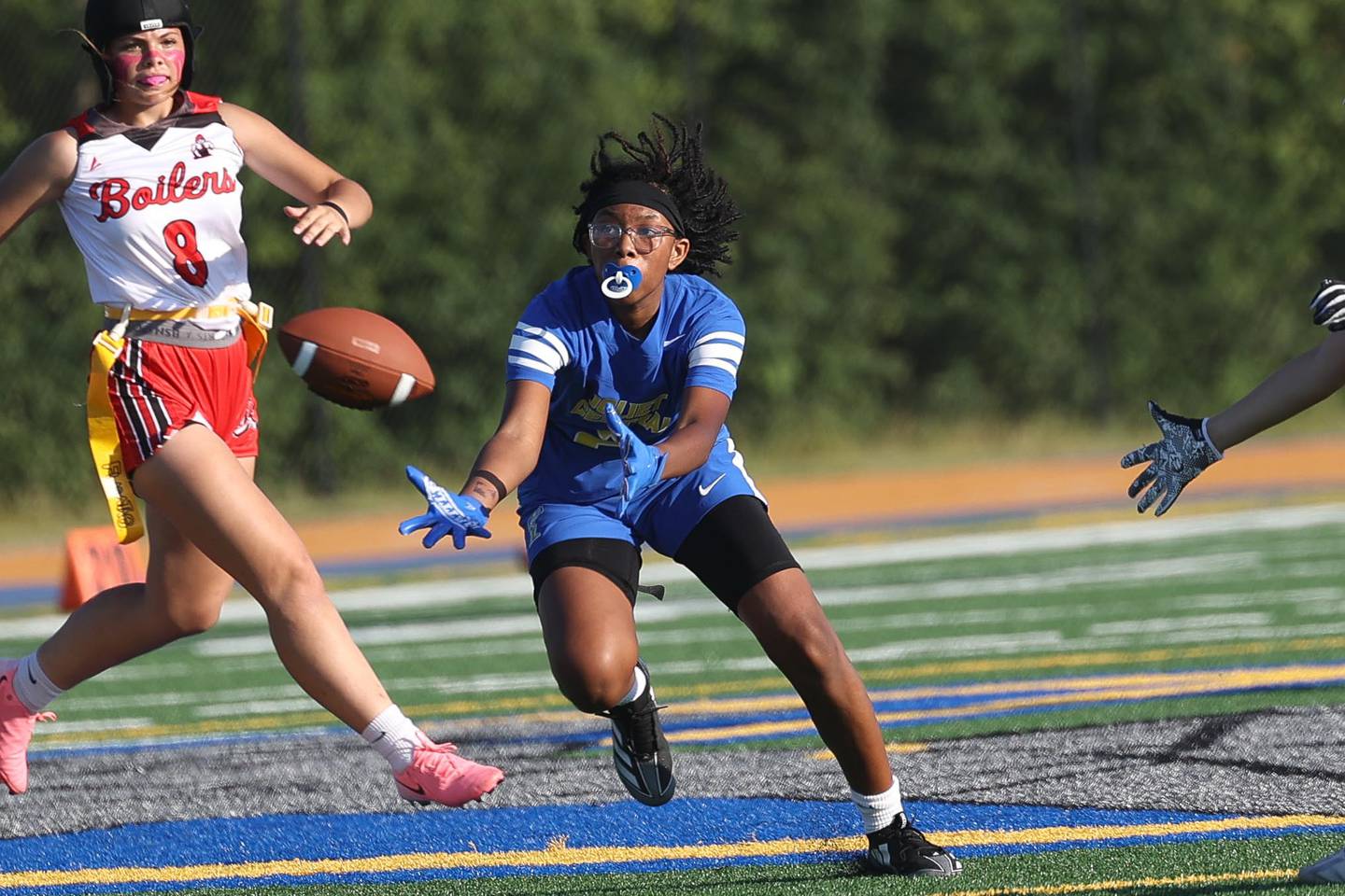 Joliet Central’s Ta’Niya Banks attempts to pull in a pass in their inaugural flag football game against Bradley-Bourbonnais on Thursday.