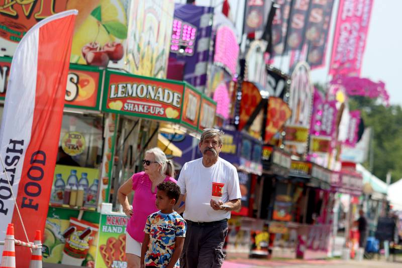 People peruse the food options as part of the McHenry County Fair in Woodstock on Tuesday, July 30, 2024.