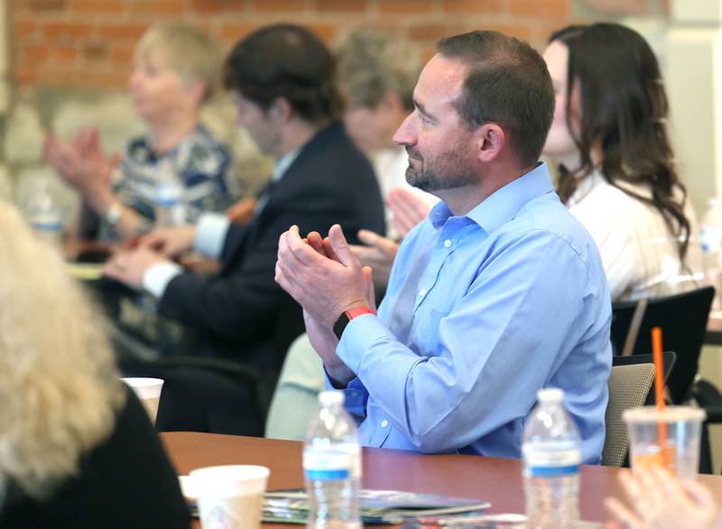 Attendees applaud a speaker Wednesday, May 1, 2024, at the Sycamore Chamber of Commerce State of the Community Address in the DeKalb County Community Foundation Freight Room.