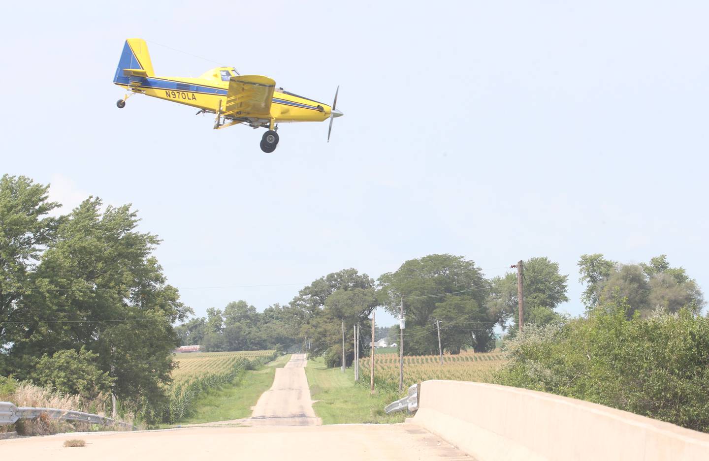 A crop duster airplane sprays a field near the intersection of East 9th Road and Interstate 80 on Monday, July 22, 2024 near Utica.