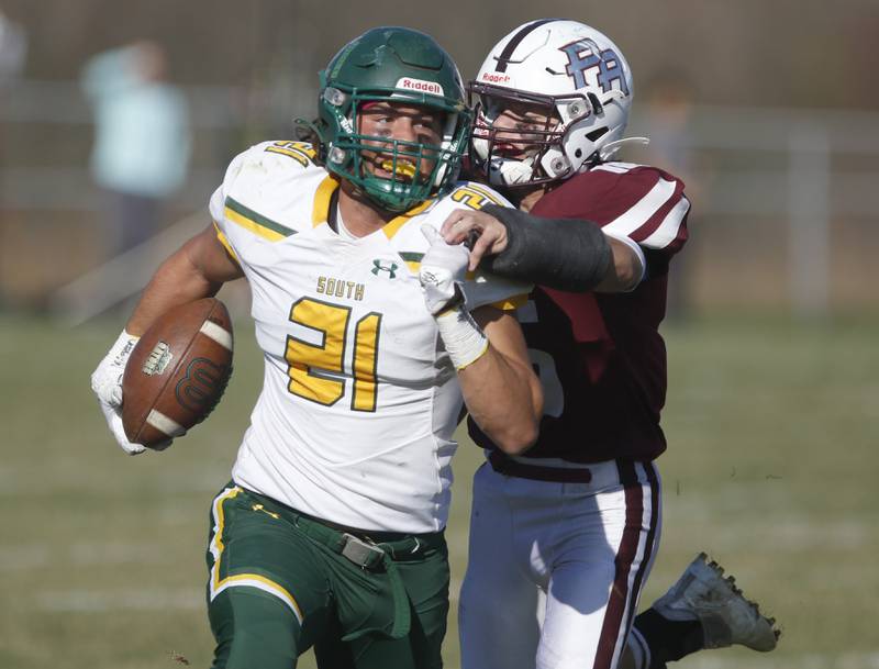 Crystal Lake South's Michael Prokos is tackled from behind by Prairie Ridge's Dominic Creatore during a IHSA Class 6A first round playoff football game Saturday, Oct. 29, 2022, between Prairie Ridge and Crystal Lake South at Prairie Ridge High School in Crystal Lake.