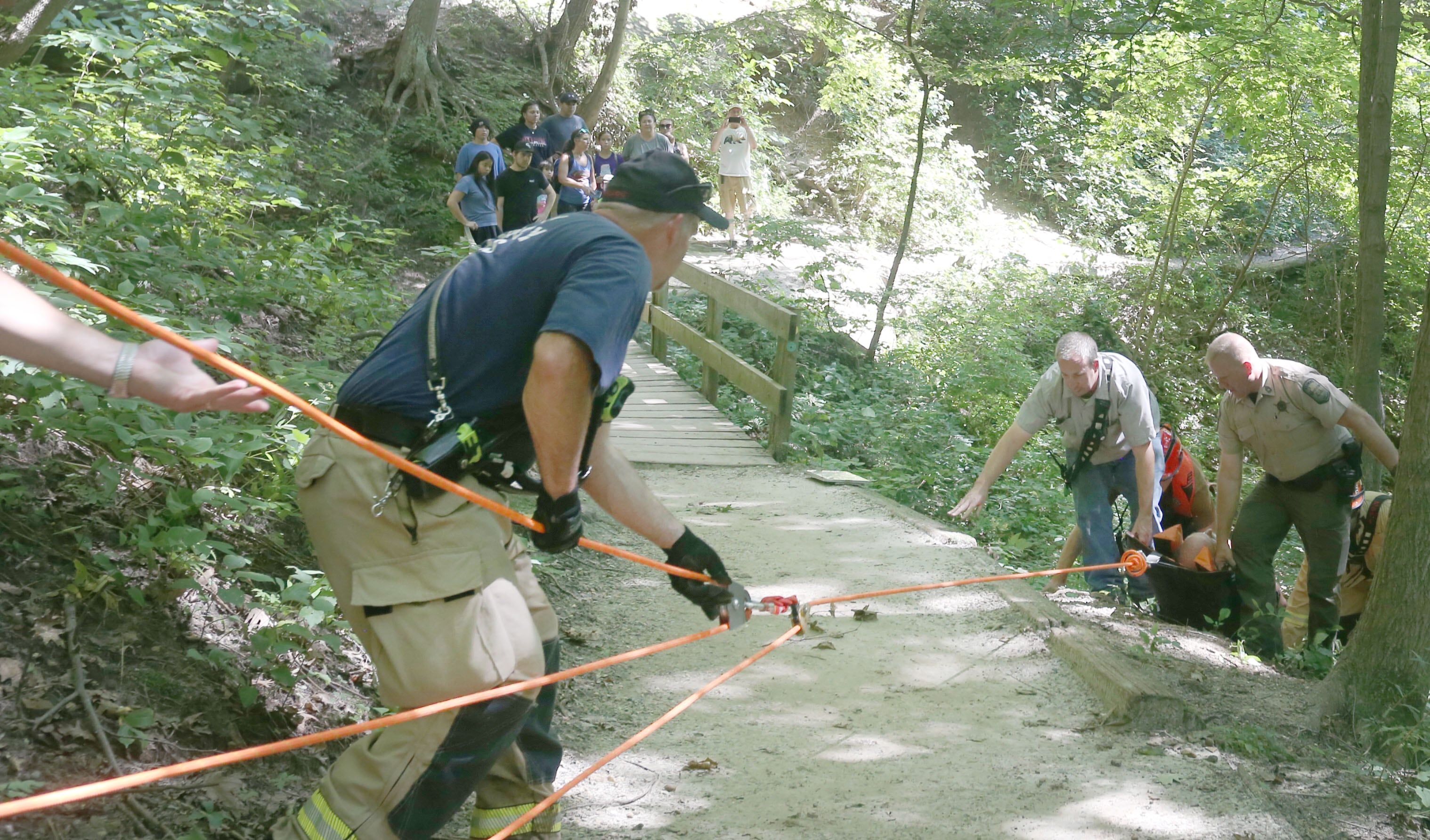 Oglesby firefighter Steve Maltas (left) conducts a rope rescue as Utica Fire Lt. James Didricksen and Conservation Police sergeant Phil Wire along with other personnel lift  a male subject up an embankment who fell at La Salle Canyon on Wednesday, July 17, 2024 at Starved Rock State Park.