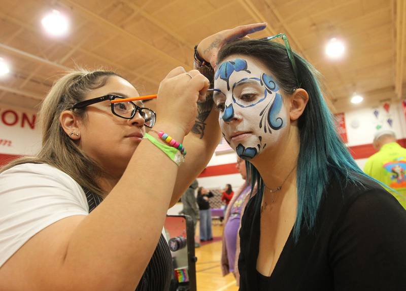 Esther Guerrero, of Waukegan with Honey's Painting, paints Sugar Skull makeup on Megan May, of Fox Lake, a teacher at Lotus Elementary School, during the Dia de los Muertos, Day of the Dead event at Stanton Middle School on November 4th in Fox Lake. The event was sponsored by the Bilingual Parents Advisory Committee (BPAC) from School Districts 114,124 and 37.
Photo by Candace H. Johnson for Shaw Local News Network