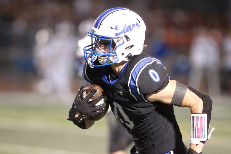 St. Charles North’s Aidan McClure runs the ball for a touchdown after an interception during a game against Wheaton North on Friday, Sept. 13, 2024, at St. Charles North.