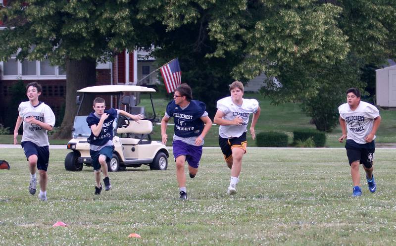 Members of the Fieldcrest football team sprint down the field while working on drills on Monday, July 8, 2024 at Fieldcrest High School.