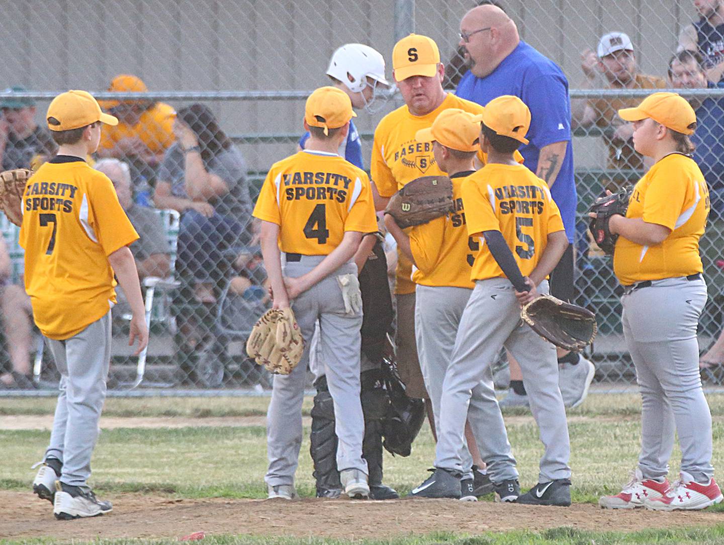 Varsity Sports head coach John Mital holds a meeting on the mound with his infield Wednesday, June 29, 2022, at Southside Diamond in Streator.