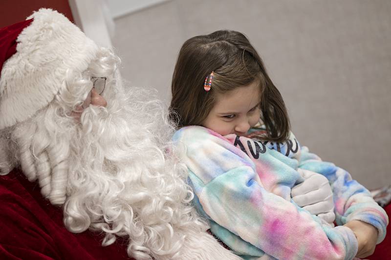 Reina Magana, 3, talks with Santa Saturday, Dec. 10, 2022 at the Dixon Walmart after an afternoon of shopping during the annual Shop with a Cop. Participants were broken up into a morning and afternoon session, with each meeting before the shopping for a meal.