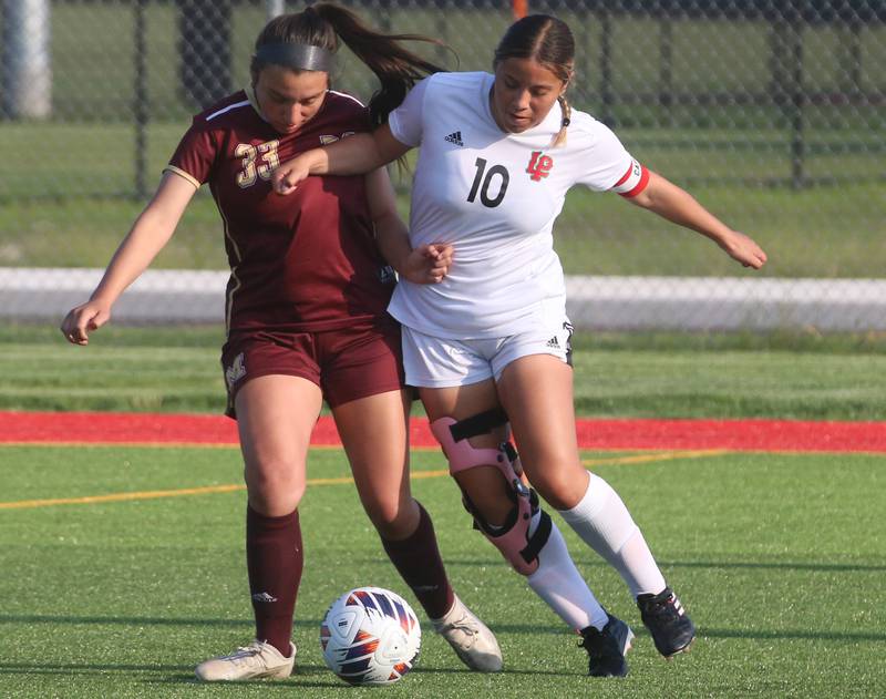 Morris's Mariah Diaz and L-P's Zara Lugo go after the ball during the Class 2A Regional semifinal game on Wednesday, May 15, 2024 at the L-P Athletic Complex in La Salle.