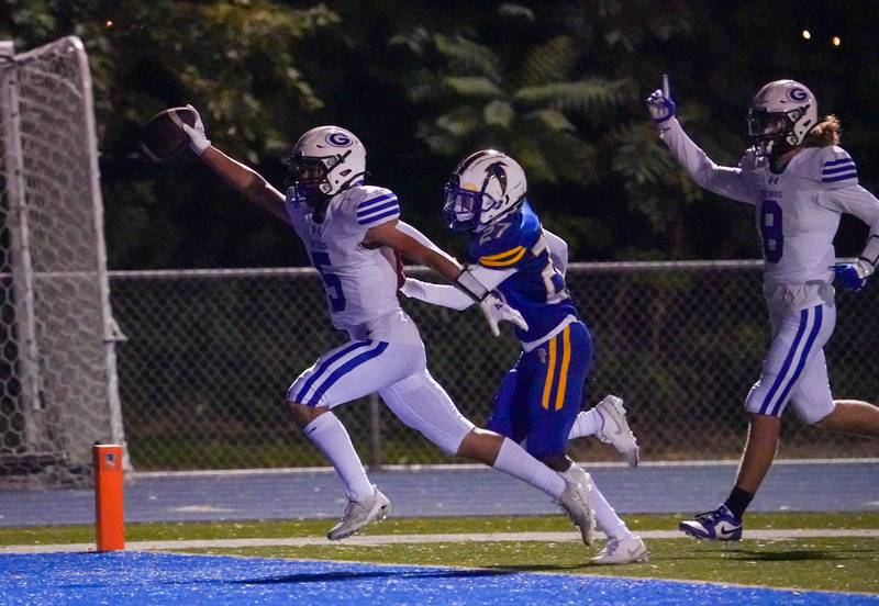 Geneva’s Dylan Reyes (5) carries the ball for a touchdown touchdown against Wheaton North during a football game at Wheaton North High School on Friday, Oct. 6, 2023.