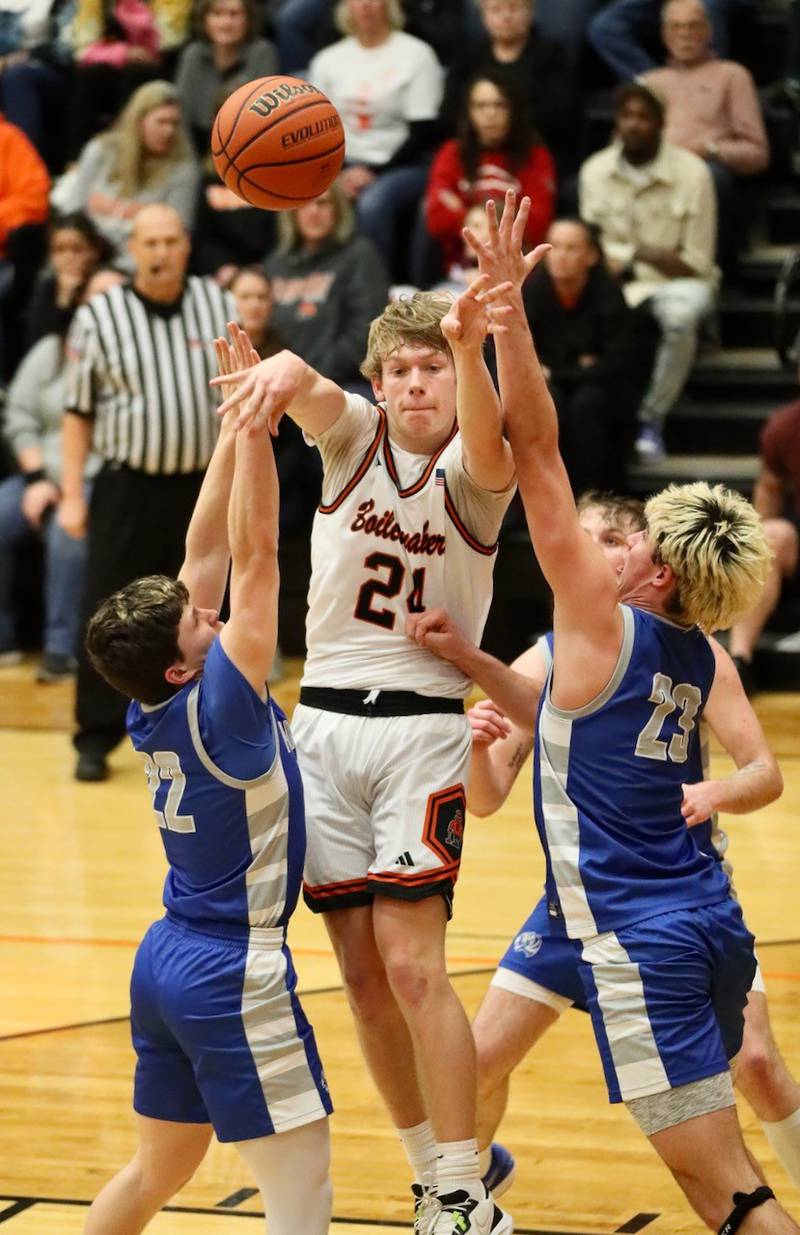 Kewanee's Brady Clark passes out of a jam guarded by Princeton's Evan Driscoll (22) and Noah LaPorte (23) Tuesday night.