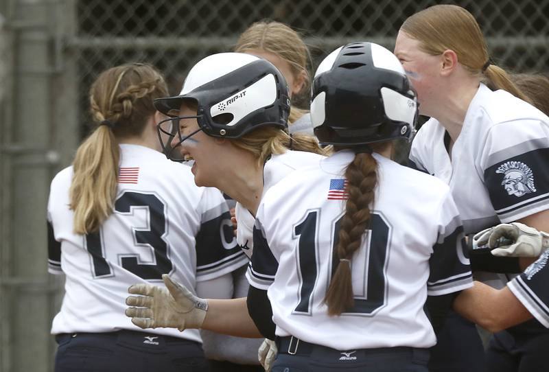 Cary-Grove’s Emily Green is mugged by her teammates after hitting a home run during a Fox Valley Conference softball game Monday, April 4, 2022, between Cary-Grove and Dundee-Crown at Cary-Grove High School.