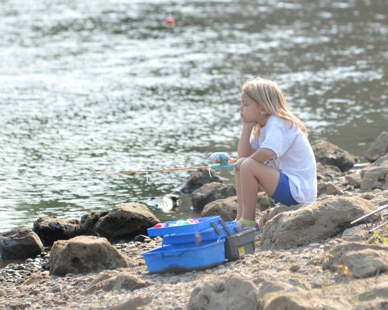 Alyannah Ekstrom, 7, of Lyndon watches her line as she fishes at the 17th Dick Brown Fishing Derby for kids at Prophetstown State Park on Saturday, June 17.