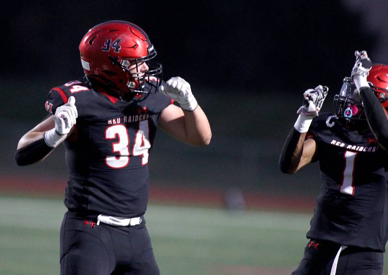 Huntley’s Haiden Janke, left, celebrates a Red Raider touchdown with Bryce Walker against Jacobs in varsity football in Huntley Friday night.