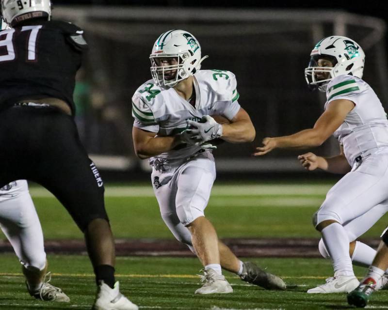 York's Jimmy Conners (34) takes the handoff during a football game between York at Plainfield North on Friday, Sept 6th, 2024 in Plainfield. Gary E Duncan Sr for Shaw Local News Network.