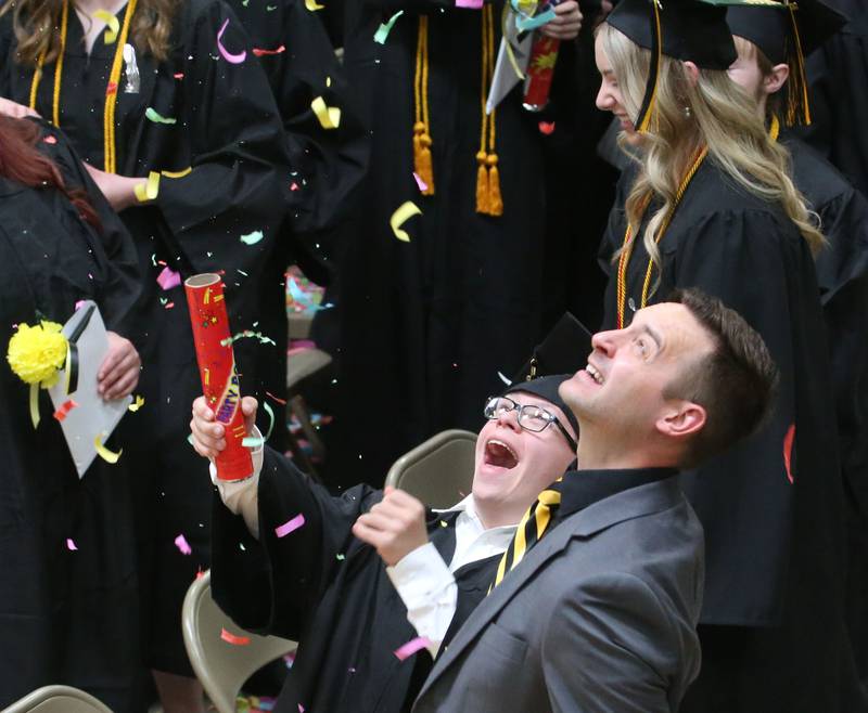 Putnam County senior Blake Baker reacts as superintendent Clayton Theisinger helps him release his confetti blaster after graduating during the Class of 2023 graduation ceremony on Sunday, May 21, 2023 at Putnam County High School.