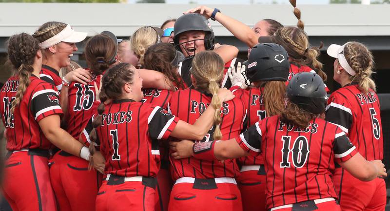 Members of the Yorkville softball team react behined hoome plate after defeating Oak Park-River Forest in thirteen innings during the Class 4A State semifinal softball game on Friday, June 9, 2023 at the Louisville Slugger Sports Complex in Peoria.