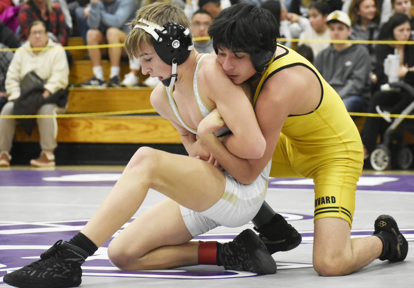 Sycamore’s Michael Olson grapples with Harvard’s Raymundo Romo during the IHSA Class 2A Rochelle Wrestling Regional on Saturday, Feb. 4, 2024.