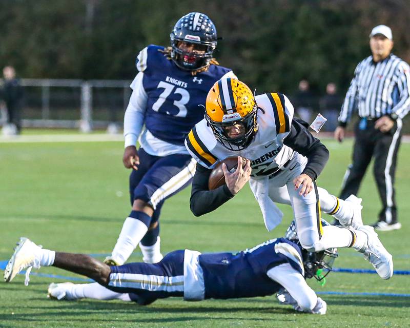 St Laurence's Evan Les (12) dives toward the endzone during Class 4A third round playoff football game between St Laurence at IC Catholic Prep.  Nov 11, 2023.