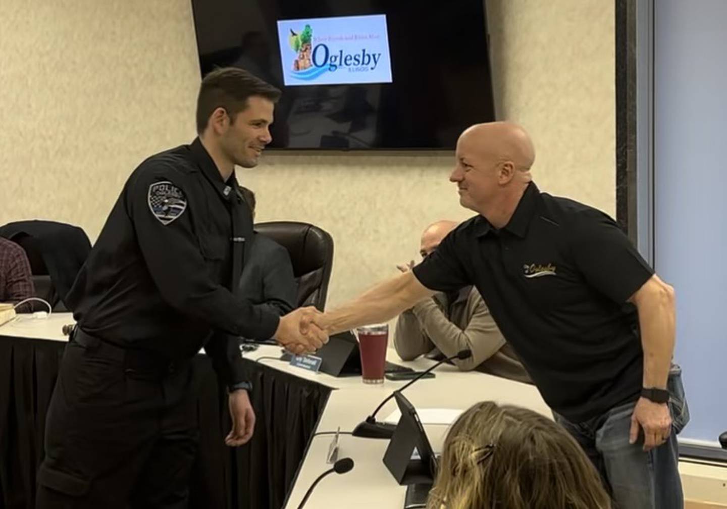 Oglesby Commissioner Terry Eutis (right) congratulates newly-sworn Oglesby police officer Spencer Shaw after Shaw's swearing-in Monday, March 18, 2024, at Oglesby City Hall.