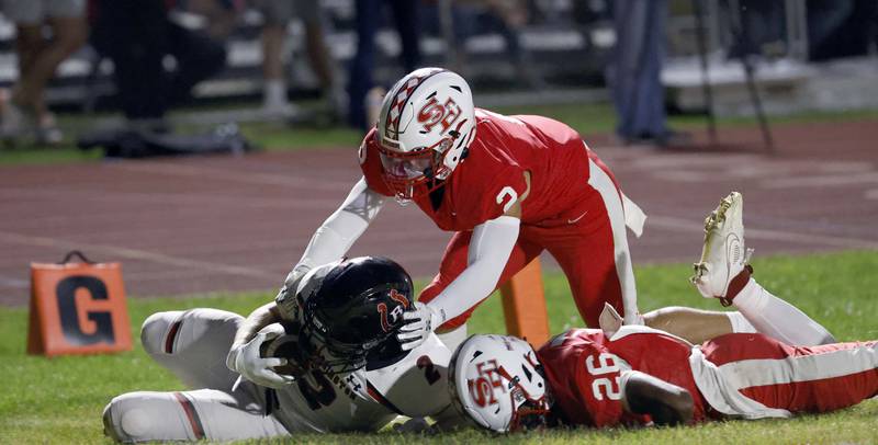 Barrington's Ian Tepas (2) slides into the end zone past South Elgin's Nico Barkho (2) and DeAngelo McCullough (26) Friday, Aug. 30, 2024 in South Elgin.