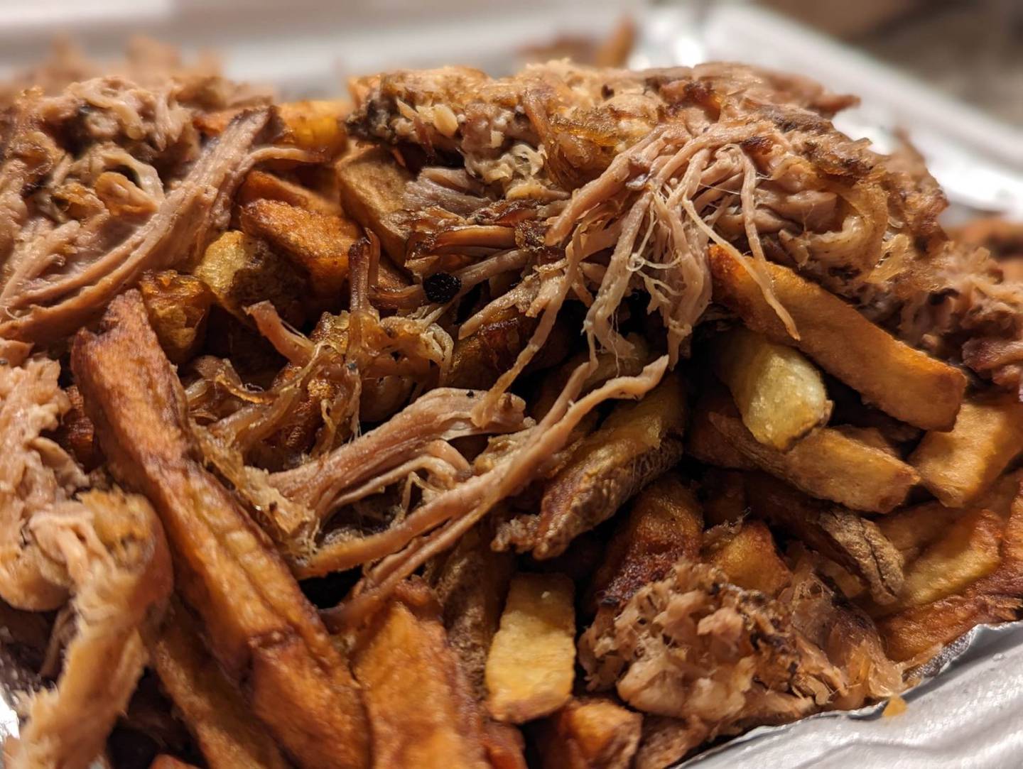 Our serving of poutine at Craft'd Plainfield was topped with shredded pork.