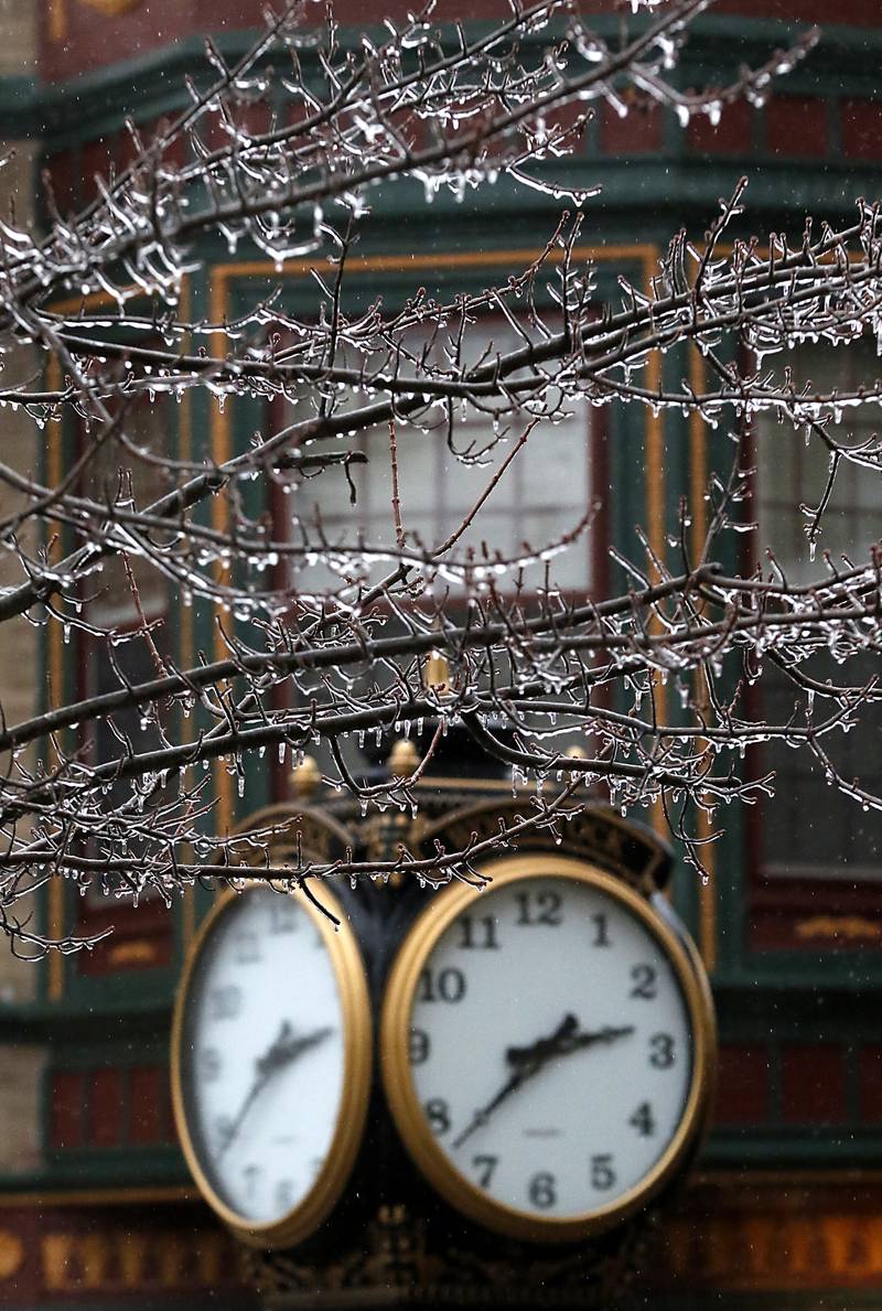 Ice hangs on a tree near the clock in the historic Woodstock Square on Wednesday, Feb. 22, 2023, as a winter storm that produced rain, sleet, freezing rain, and ice moved through McHenry County.
