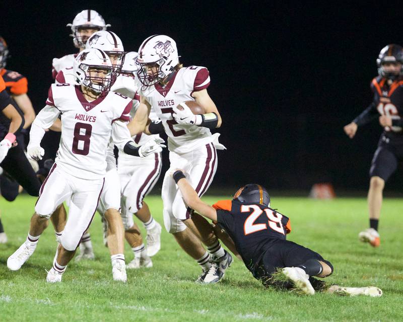 Prairie Ridge's Logan Thennes tries to avoid the tackle by Crystal Lake Central's Jon Horbenko on Friday, Oct.18, 2024 in Crystal Lake.