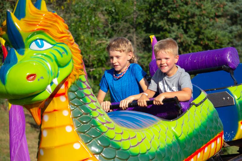 Children of Ottawa ride Dragon Rollercoaster on Friday, June 21, 2024 at the Ottawa Lions Club Carnival in Ottawa.