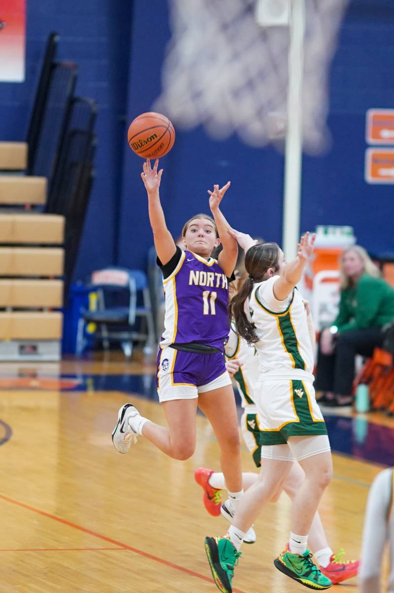 Downers Grove North's Abby Gross (11) shoots a half court shot at the end of the third quarter against Waubonsie Valley during a Oswego semifinal sectional 4A basketball game at Oswego High School on Tuesday, Feb 20, 2024.