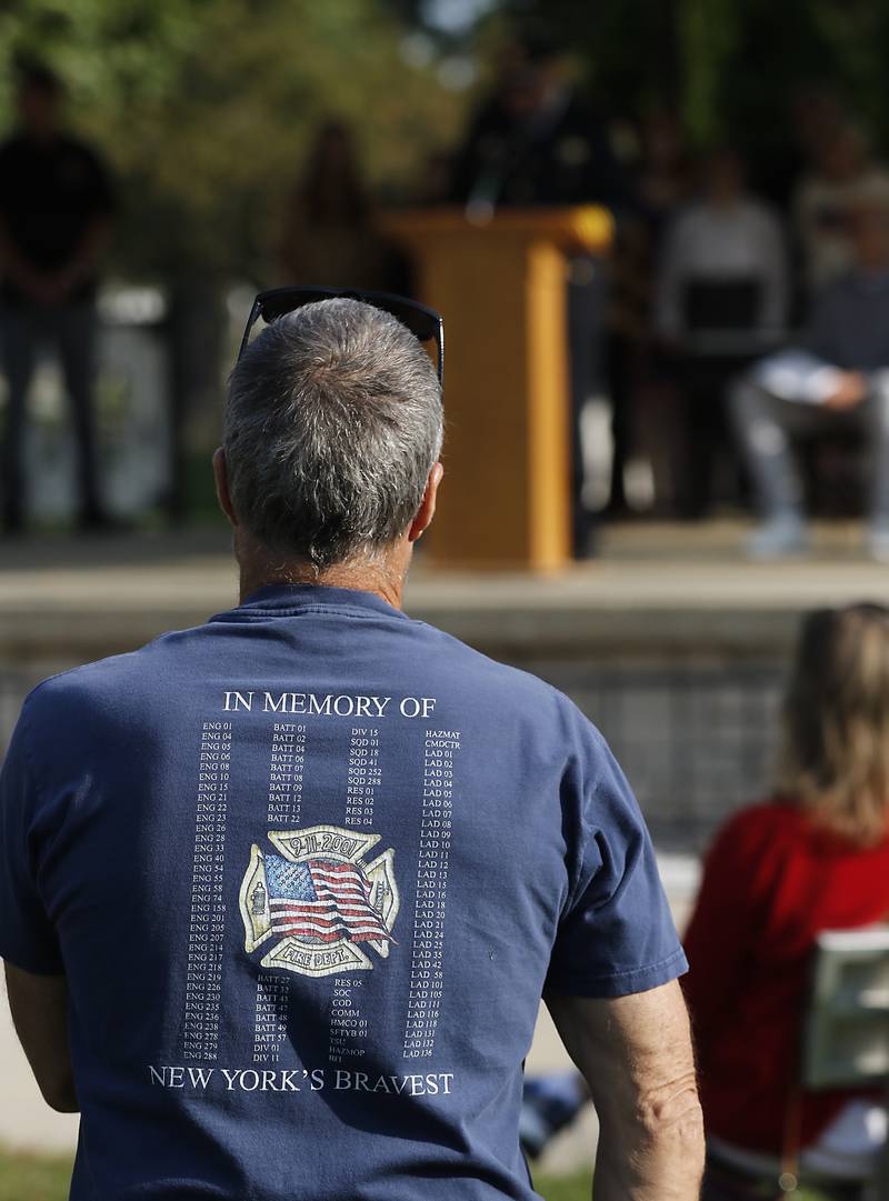 A person listen to McHenry Chief of Police John Birk as he speaks during a 9/11 remembrance ceremony on Sept. 11, 2024, at Veteran's Memorial Park in McHenry.