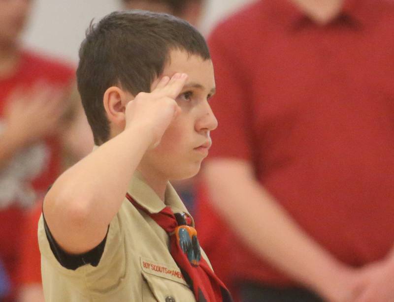 Johnathan Michael, Parkside School student and Boy Scout Troop #123 member salutes the American Flag while presenting the colors during the Parkside School Veterans Day Program on Friday, Nov. 10, 2023 at Parkside Middle School in Peru.