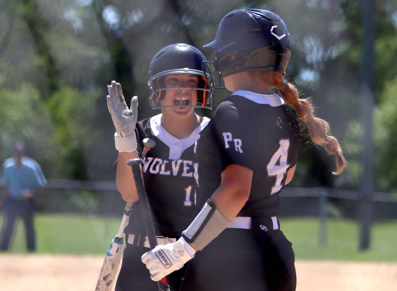 Prairie Ridge’s Emily Harlow, left, and Emma Dallas celebrate during a win over Harvard during Class 3A softball regional final action at Lions Park in Harvard Saturday.