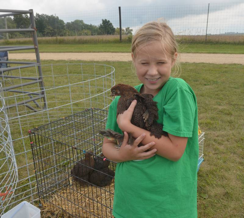 Delaney Byers, 9, of Forreston, smiles as she holds one of her chickens at the Summerhill Huskies 4-H Club's petting zoo at BerryView Orchard on Sunday, Sept. 17, 2023.