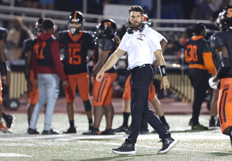 DeKalb head coach Derek Schneeman greets his team as they come off the field during their game against Metea Valley Friday, Sept. 16, 2022, at DeKalb High School.