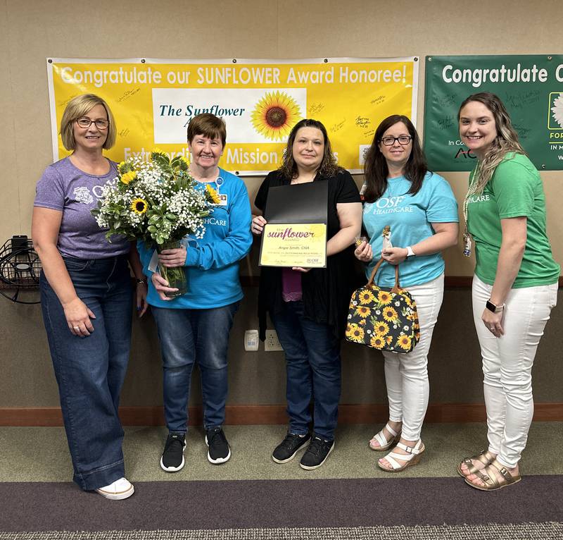 Angie Smith, CNA and 2024 Sunflower Award winner is pictured with OSF Saint Luke leaders.
