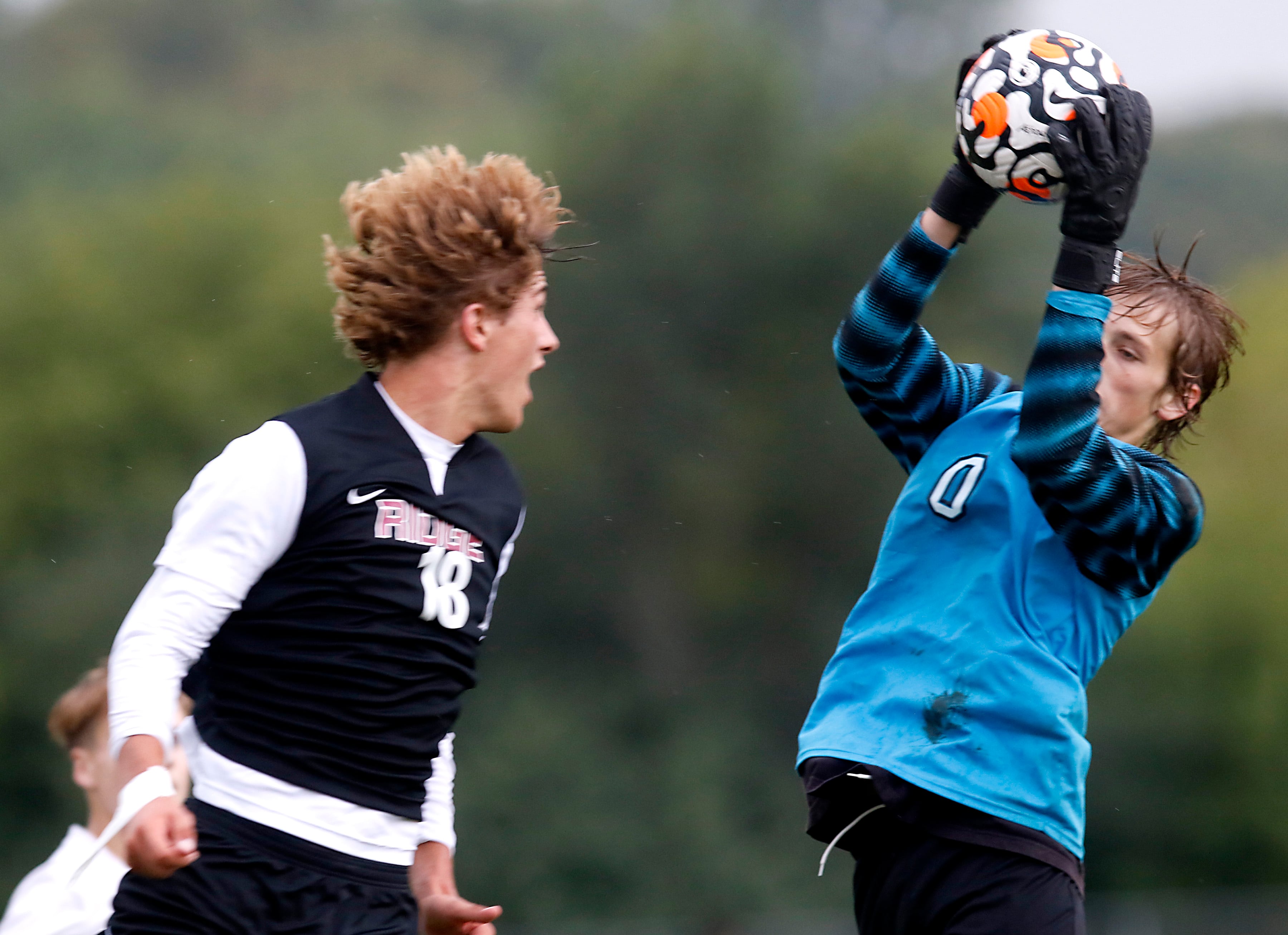 Prairie Ridge's Henry Knoll watches as Hampshire's Parker Smith grabs the ball during a Fox Valley Conference soccer match Tuesday, Sept. 19, 2023, at Prairie Ridge High School in Crystal Lake.