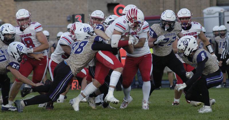 Oregon running back Hunter Bartel is tackled by Dixon's Devon Wallace. Oregon traveled to AC Bowers field to play the Dukes on Friday, Sept. 7,2024