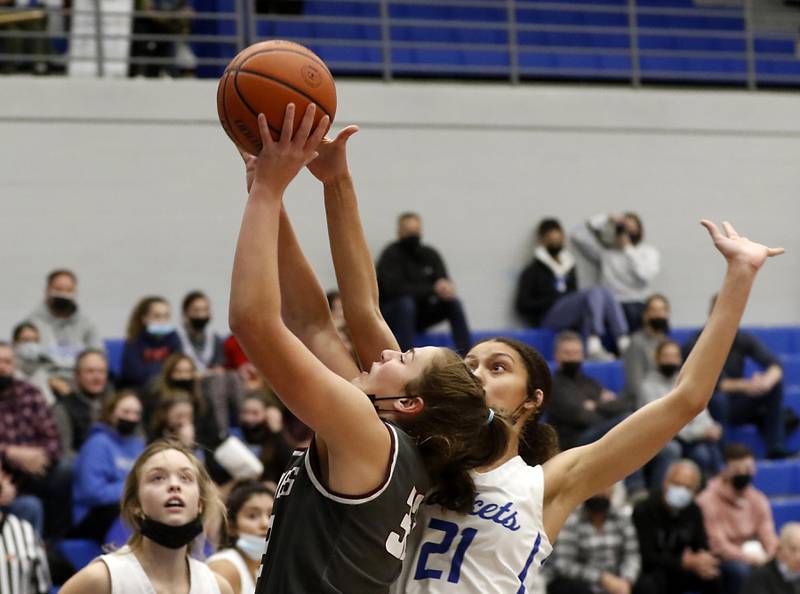 Prairie Ridge's Kelly Gende has her shot blocked by Burlington Central's Taylor Charles as Gende drive to the basket during Fox Valley Conference girls basketball game Monday evening, Jan. 31 2022, between Prairie Ridge and Burlington Central at Burlington Central High School.