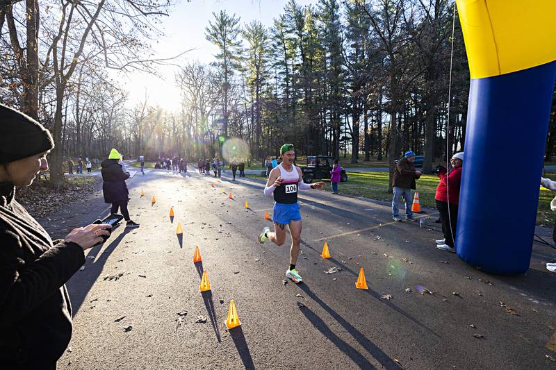 Blain Masterson of Dixon crosses the finish line Thursday, Nov. 23, 2023 to win the St. Anne’s 12th Annual Turkey Trot. The route was a 3.1 mile run through the upper and lower sections of Lowell Park in Dixon.